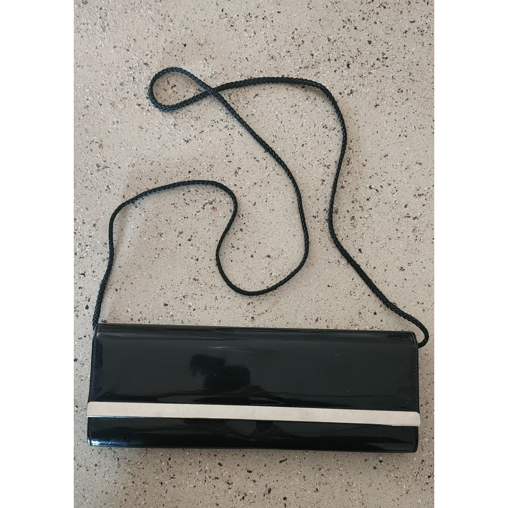 Clutch Purse - Pre-owned. In great shape. Shiny black with silver bar